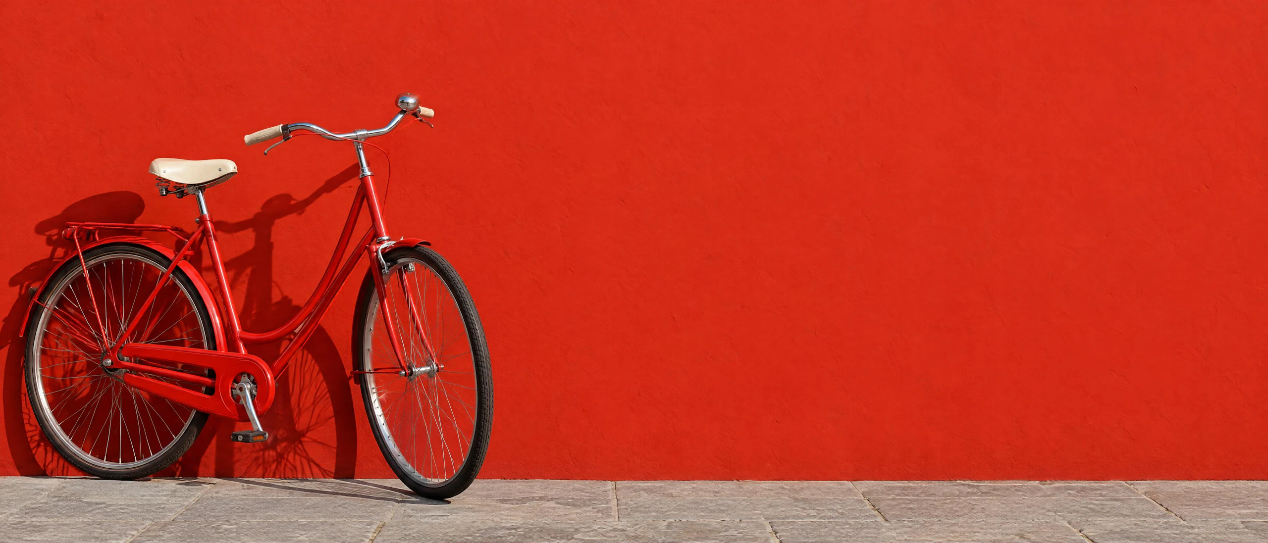 A red vintage bicycle leans against a tomato-red wall in hard sunlight. Made with GPT Image 2.5 Flare.
