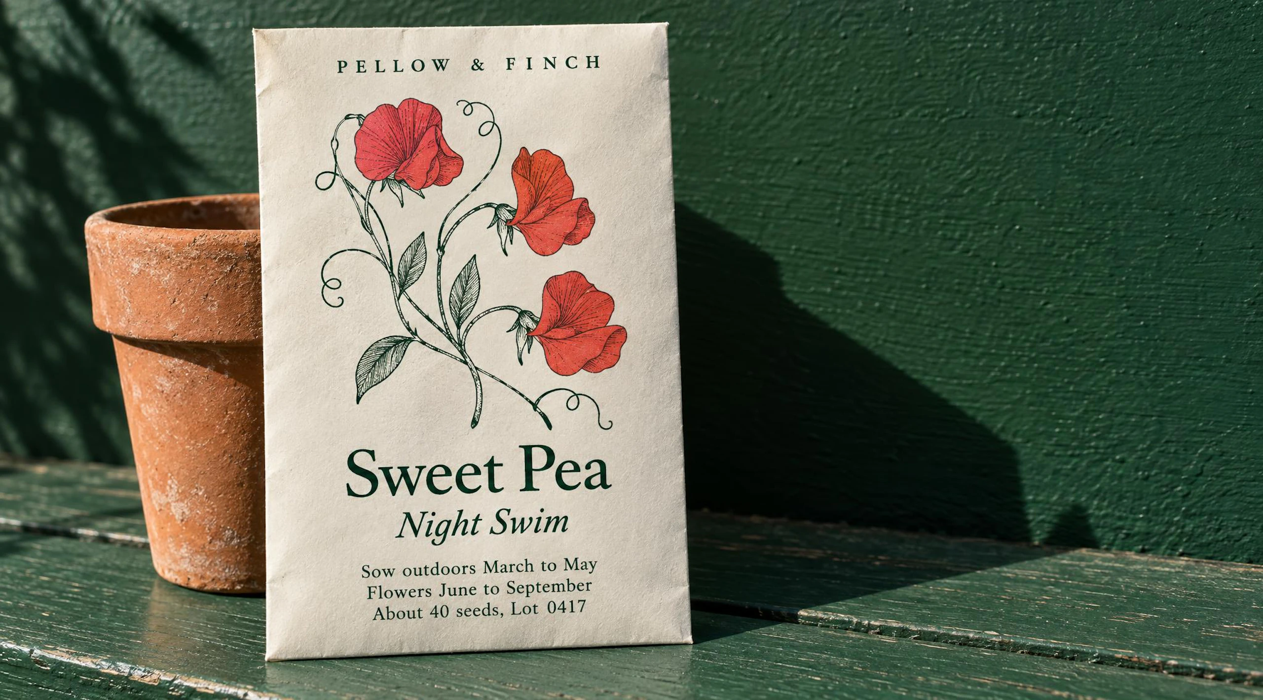 Seed packet printed "Pellow & Finch, Sweet Pea, Night Swim" with a red sweet pea illustration and planting details, propped beside a terracotta pot on a green bench. Made with GPT Image 2.5 Sunburst.